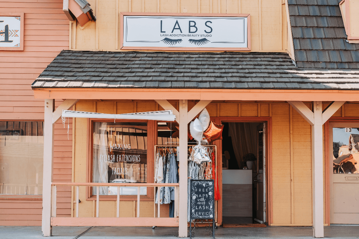 Peach-toned LABS storefront, with the studio sign above a covered entrance in South West Plaza.